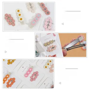 Detail showing the cotton daisy hair clip set with protective cloth covering the metal clip