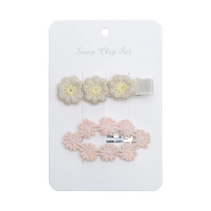 Detail of baby daisy snap clip set with embroidered flowers and crochet lace on card
