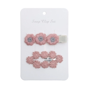 Detailed embroidery of pink daisy flower snap clips on a white presentation card