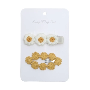 Detail of embroidered white daisy and yellow floral pattern snap clips for kids