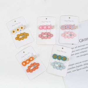 Five sets of colorful knitted daisy flower snap hair clips for baby girls on cards