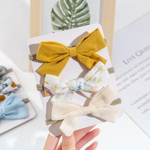 Set of three floral bow headbands for baby girls in yellow, flower, and plaid cotton patterns