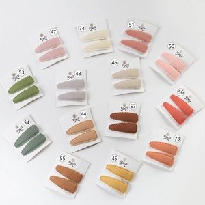 Detailed view of 13 colorful fabric edge BB hair clips with wavy texture on display cards