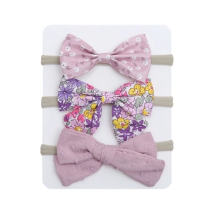 Close-up of three pieces baby bow headbands in floral and polka dot fabric textures
