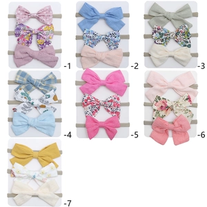 Set of 3 baby bow headbands with floral and polka dot patterns on high-elastic nylon bands