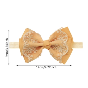 Detail of baby lace bow headband showing 4.72-inch width and soft elastic nylon band
