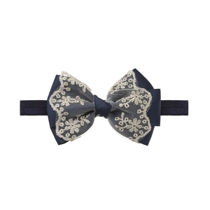 Detail of navy blue lace bow headband with gold thread embroidery on elastic nylon band