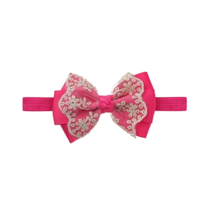 Detailed view of pink double-layered lace bow headband with floral embroidery for baby girls