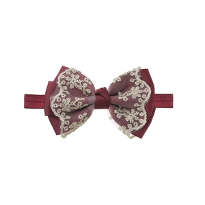 Detail of burgundy embroidery lace bow headband with elastic nylon band for baby girls