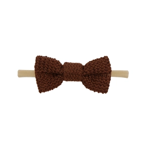 Detail of baby headband with a dark brown knit bow and soft seamless nylon elastic band
