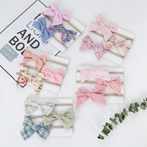 Detail showing 15 pieces of baby bow headbands with floral prints and solid colors