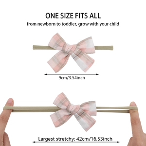 Elastic baby headband showing stretch length from 9cm to 42cm for newborn to toddler