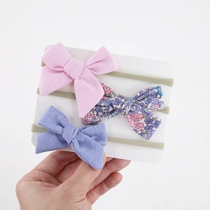 Three-piece set of soft baby nylon headbands with floral and solid color ribbon bows