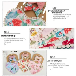 Detailed view of floral cotton baby bib and bow headband set with pom-pom trim and linen texture