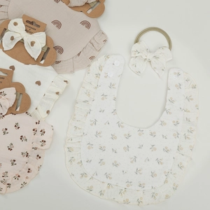 Cotton gauze baby bib and headband set with floral prints and ruffle edge details