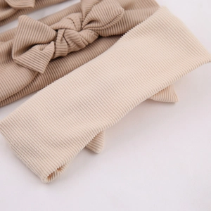 Soft ribbed knit baby headband with bow in beige and khaki colors for newborns