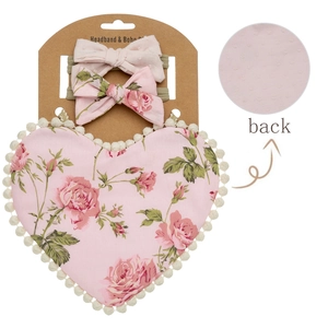 Detail of baby floral bib with heart pattern and matching headbands on card