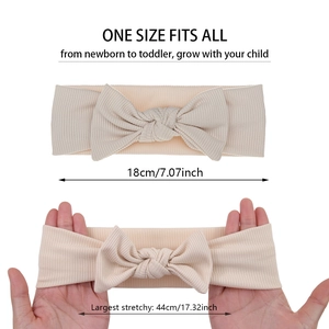 Detail of ribbed baby headband showing high elasticity from 18cm to 44cm in beige