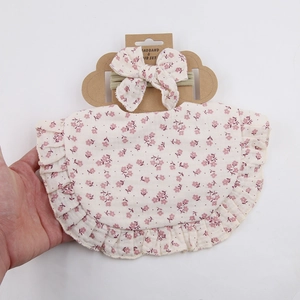 Floral baby bib and headband set on cloud cardboad with elegant ruffle edge detail