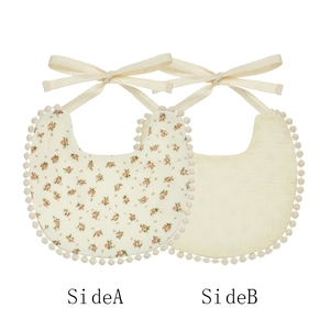 Dual-sided cotton baby bib with floral print, solid color side and tassel edge