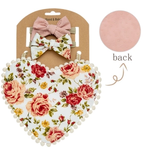 Detail of floral baby bib and bow headbands showing high-quality back fabric texture