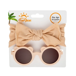 Detail of baby bear ears sunglasses and matching bow headband on a white display card