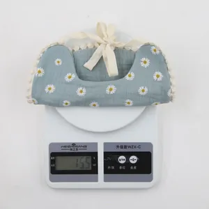 Lightweight 15.5g blue baby bib with white daisy print and delicate lace trim