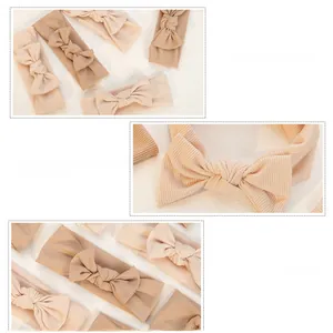 Detail of ribbed fabric and handmade bow on skin-friendly baby headband in nude tones