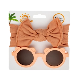 Detail of baby bear ears sunglasses and matching nylon bow headband on display card
