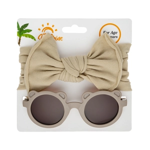 Detail view of khaki bear-eared sunglasses and large bow nylon headband set for babies