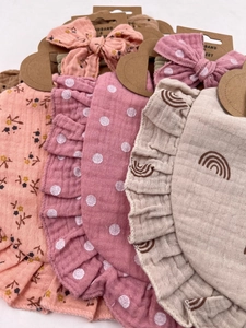 Floral and rainbow baby muslin bib and headband sets on kraft display cards