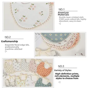 Close-up of 100% cotton floral baby bibs with delicate lace trim and soft fabric