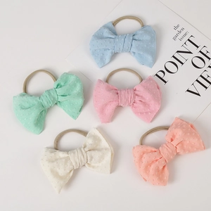 Five pack of soft jacquard dotted nylon baby headbands with bows in pastel colors
