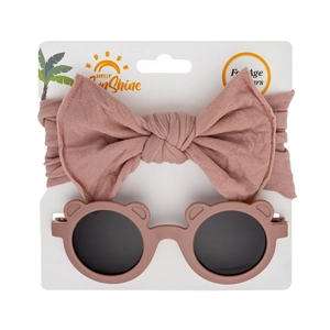 Detail of pink bow nylon headband and bear ear sunglasses on display card for infants