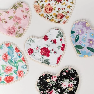 Floral cotton heart bib set with pom-pom trim and red rose patterns on white background