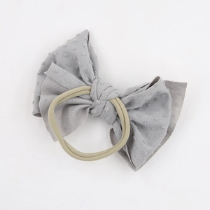 Soft nylon baby headband with a grey jacquard polka dot bow for infants and kids