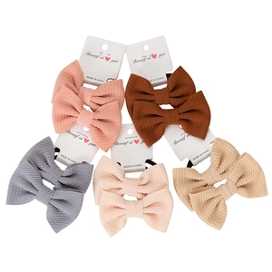 Close-up of waffle texture bubble fabric hair bows on cards for baby girls