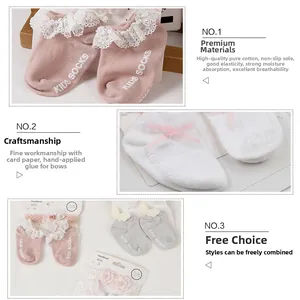 Detail showing non-slip dots on cotton baby socks and matching lace headband set