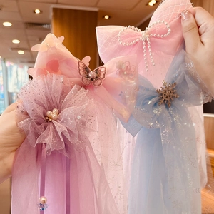 Detailed view of chiffon bow hair clips with pearls and sequins for flower girls