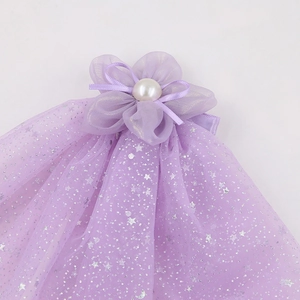 Detail of purple chiffon flower hair clip with pearl center and star sequin mesh veil