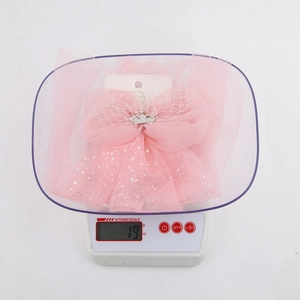 Detail of pink chiffon mesh hair bow with silver crown and star sequins weighs 19g