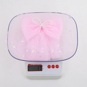 Pink chiffon hair clip with silver stars and pearl bow decoration weighing 17 grams