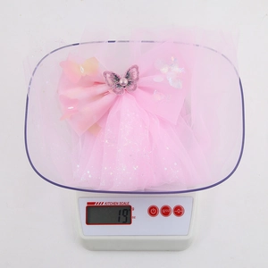 Pink chiffon veil hair clip for girls showing a lightweight weight of 19g on a scale