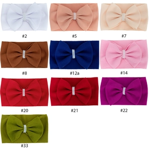 Set of 10 elastic waffle fabric baby headbands with large bows and pearl accents