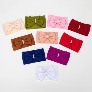 Detailed view of 10 waffle texture baby headbands with elegant pearl center bows