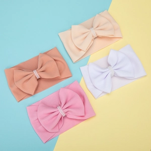 Set of 4 ribbed knit baby headbands with large bows and delicate pearl accents