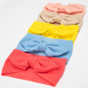 Detail showing five-piece baby headbands set with waffle texture fabric and bow accents