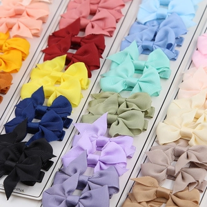 Dettaglio di fiocchi per capelli colorati in nastro grosgrain su cartoncini