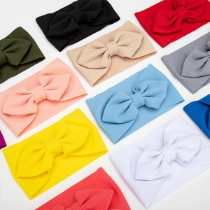 Set of 12 waffle texture baby headbands with oversized bows in multiple vibrant colors