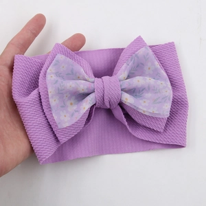 Detail of purple baby headband with floral chiffon bow and textured knit fabric
